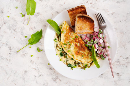 Healthy breakfast. Omelette with sorrel, cheese and radish salad. Keto, ketogenic lunch. Top viewの写真素材