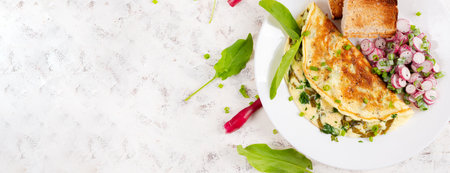 Healthy breakfast. Omelette with sorrel, cheese and radish salad. Keto, ketogenic lunch. Top view,...