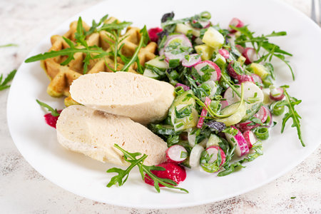 Breakfast homemade chicken sausage with waffle and fresh salad. Keto, ketogenic breakfast. Trendy breakfast.の写真素材