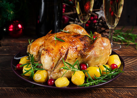 Baked chicken or baked turkey. The Christmas table is served with a turkey. Fried chicken, table setting. Christmas dinner.の写真素材
