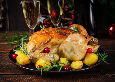 Baked chicken or baked turkey. The Christmas table is served with a turkey. Fried chicken, table setting. Christmas dinner.の写真素材