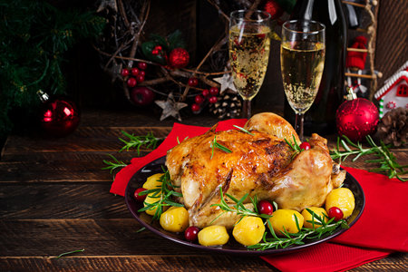 Baked chicken or baked turkey. The Christmas table is served with a turkey. Fried chicken, table setting. Christmas dinner.の写真素材
