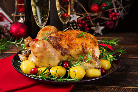 Baked chicken or baked turkey. The Christmas table is served with a turkey. Fried chicken, table setting. Christmas dinner.の写真素材