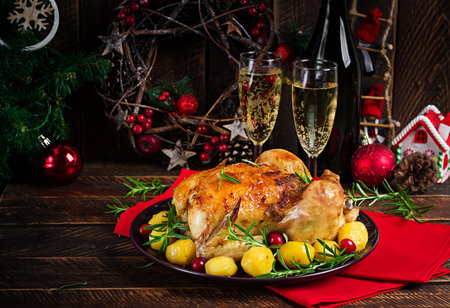 Baked chicken or baked turkey. The Christmas table is served with a turkey. Fried chicken, table setting. Christmas dinner.の写真素材