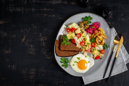 Healthy vegetarian breakfast. Fried egg, whole grain bread, and a vegetable salad. Top viewの写真素材
