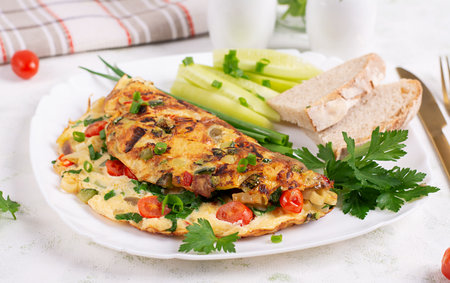 Omelet with vegetables and herbs. Healthy breakfast.