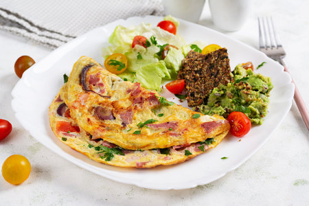 Omelette with ham and vegetables. Healthy breakfast.の写真素材