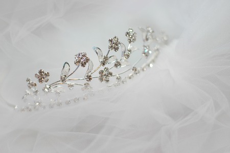 wedding bride tiara lying on a white veilの写真素材