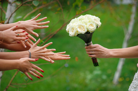 bride stretches a beautiful wedding bouquetの写真素材