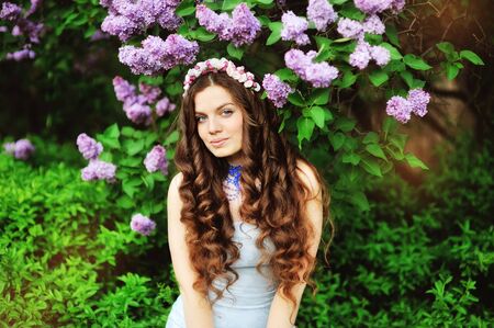 beautiful young girl on a background of flowering treesの写真素材