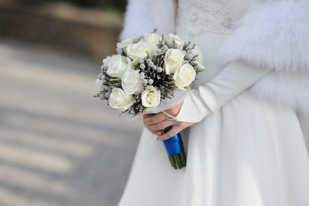 Bride holding white wedding bouquet.の写真素材