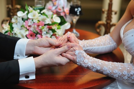 groom holds his bride's hand in appartaments.の写真素材