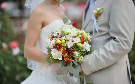 Bride holding wedding flower bouquet of white rosesの写真素材