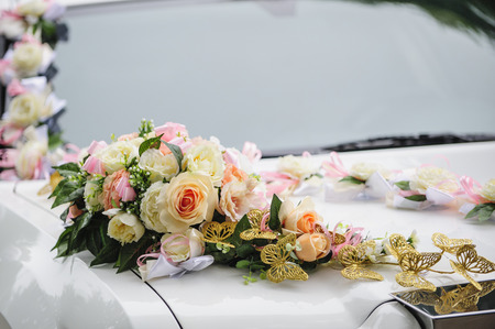 Wedding car decoration of flowers with roses and butterfliesの写真素材