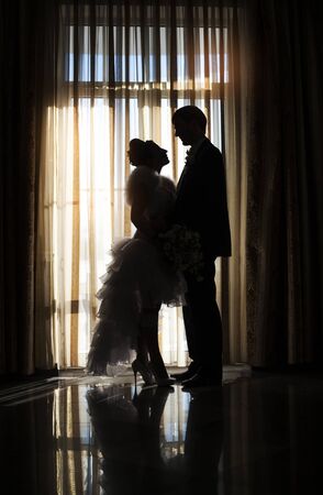 Silhouette of bride and groom in wedding dayの写真素材