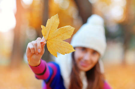 Young woman with autumn leaves.