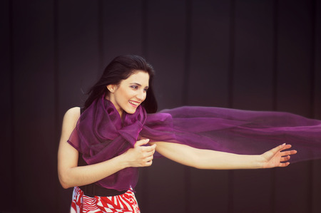 Happy girl with a scarf.の写真素材