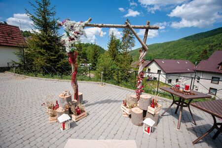 Beautifully decorated wooden wedding arch for the ceremonyの写真素材