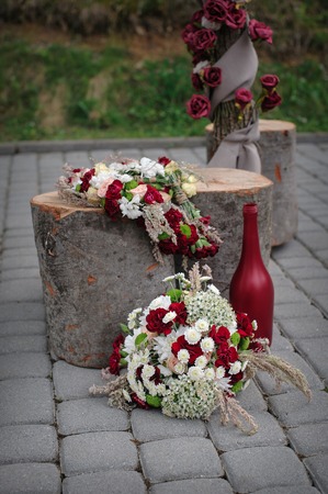 Beautiful wedding decor of flowers and wooden logsの写真素材
