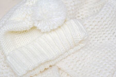 Knit woolen texture. Fabric beige background.