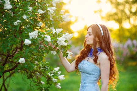 beautiful woman in the spring garden lilac.の写真素材