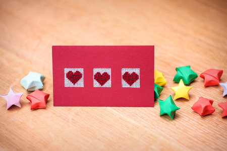 card with hearts on a wooden background.の写真素材