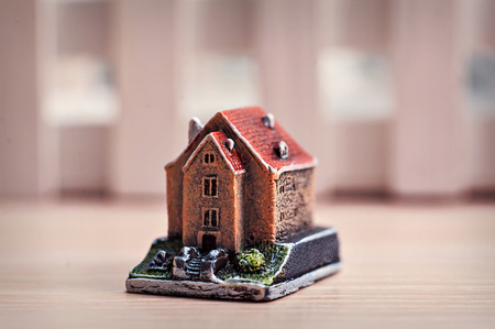 little toy house on a wooden background.の写真素材