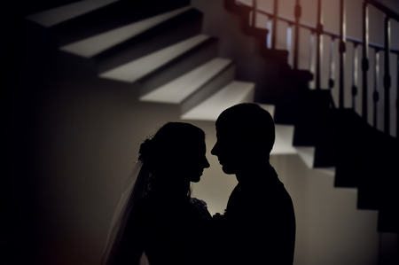 silhouette of the bride and groom at a wedding.の写真素材