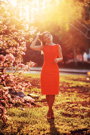 woman in spring garden setting sun.の写真素材