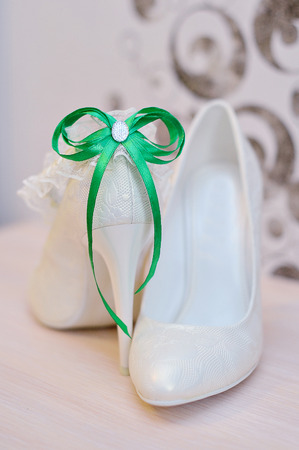 Elegant bridal shoes and a white garter.の写真素材