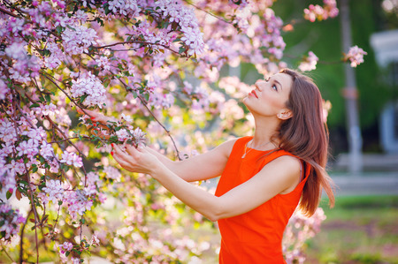 woman smelling a spring of spring flowers in the garden.の写真素材