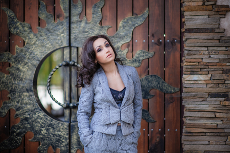 Beautiful girl on a background of wooden gates.の写真素材