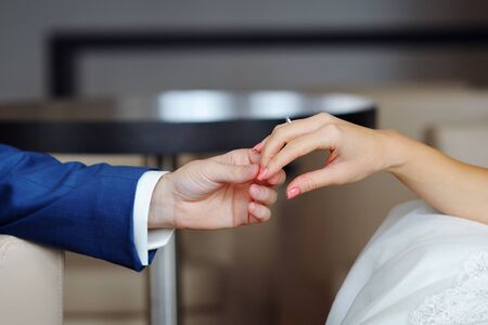 The groom holds the bride's hand.の写真素材