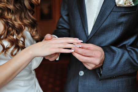 groom dresses bride wedding ring.の写真素材