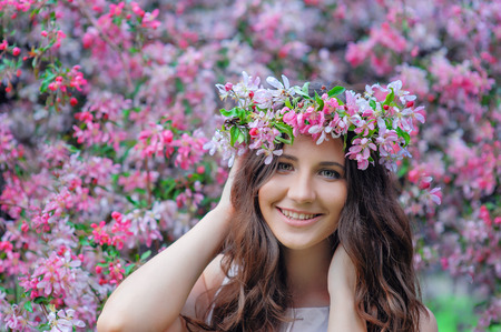 young woman in a park with a spring wreath.の写真素材