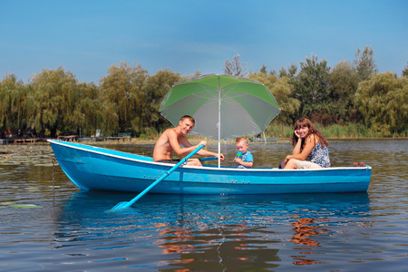 family riding on a boat in the summer.の写真素材