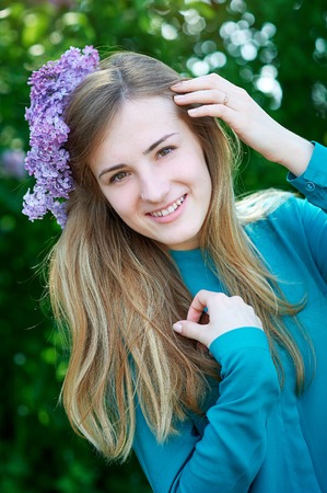 beautiful spring young woman in a park.の写真素材