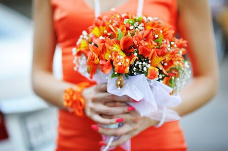 Bridesmaid holding a bouquet of pink.の写真素材