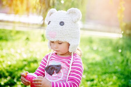 little girl walks in the summer parkの写真素材