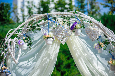 Fragment of creatively decorated wedding arch with natural flowersの写真素材