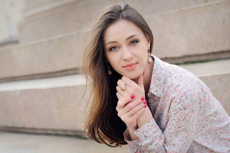 Beautiful brunette woman on street at sunny day.の写真素材