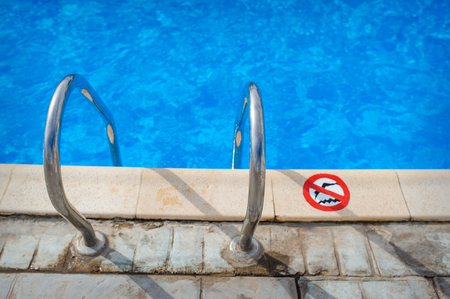 Swimming pool with stair at hotel close up.の写真素材