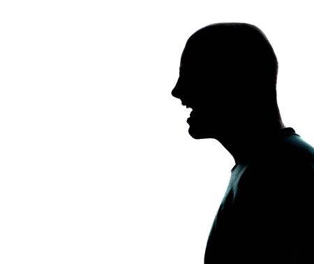 one caucasian man portrait silhouette profile screaming angry in studio on white background.の写真素材