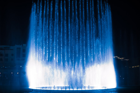 beautiful dancing fountain illuminated at nightの写真素材