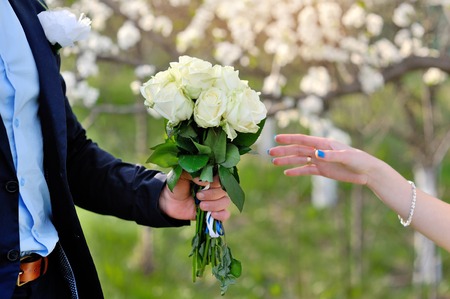 groom gives the bride a beautiful wedding bouquet.