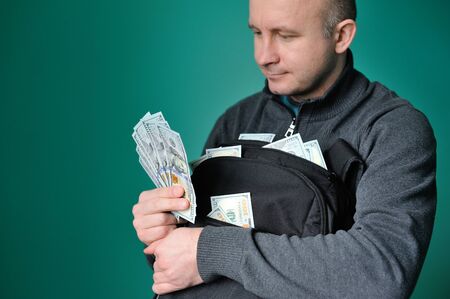 Business Man Displaying a Spread of Cash.の写真素材
