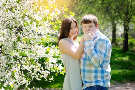 young couple in love in the blossoming spring garden.の写真素材