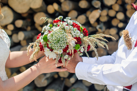 groom gives the bride a beautiful wedding bouquet.の写真素材