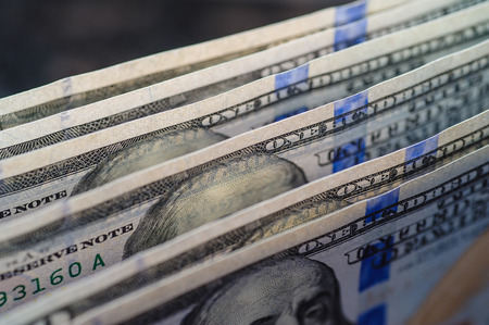 Close up of stack one hundred dollar bills.の写真素材