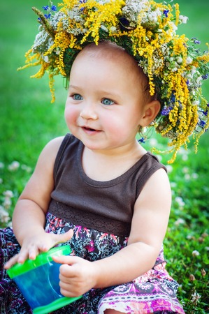 Lovely little baby girl with daisy wreath on her headの写真素材